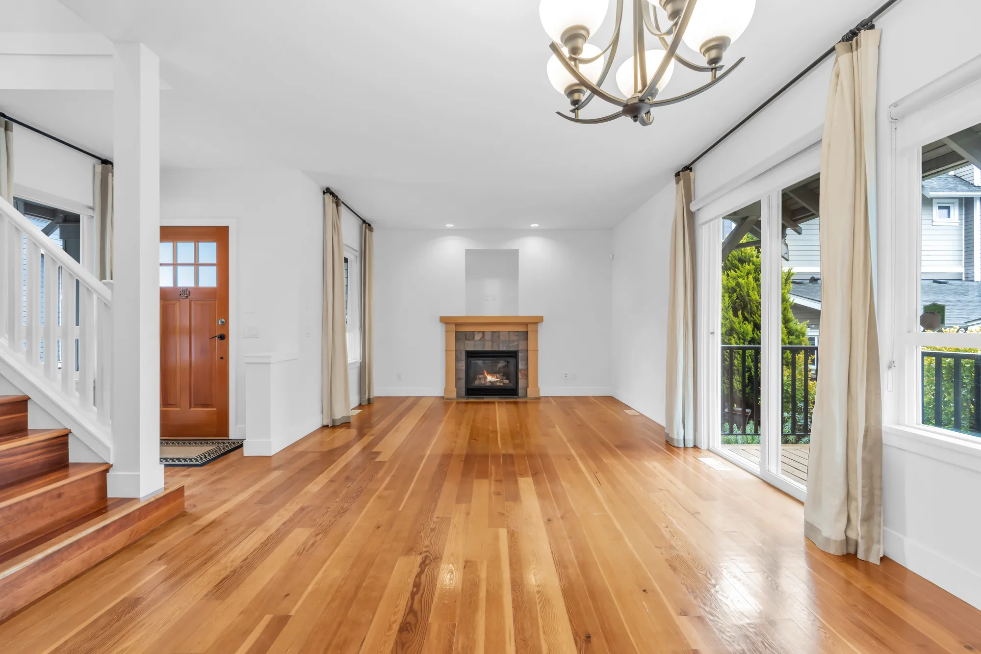 The living and dining room toward the front door, the poster for the 3D tour
